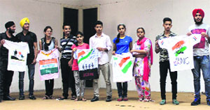 Students of GNA-IMT Multimedia show their work on T-shirt after the competition