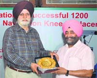 Ludhiana Municipal Corporation Mayor HS Gohalwaria felicitates Dr Balwant Singh Hunjan (right) in Ludhiana on Tuesday. Tribune Photo: Inderjeet verma