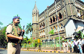 A policeman stands guard outside the Mumbai High Court.