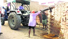 Drilling in progress to install an electricity pole in Pakka Kalan village on Tuesday.