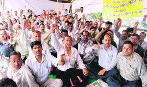 Revenue ameens hold a dharna in support of their demands in Dehradun on Tuesday.