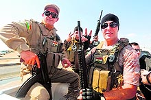 Kurdish peshmerga fighters head to the front line of fighting with Islamic State militants at Mosul Dam on the outskirts of Mosul