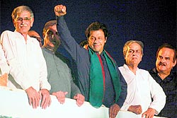 Pakistan Tehreek-e-Insaf chief Imran Khan gestures to his supporters during a Freedom March to Parliament in Islamabad on Tuesday