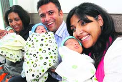 Pooja Lalseta, her husband and mother hold the month-old triplet boys at a private hospital in Mohali on Wednesday. Tribune photo: Vicky Gharu