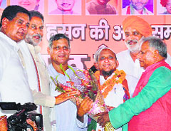 Haji Amir Husain (C) after joining the BJP on Wednesday.