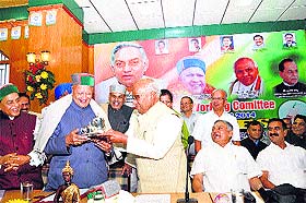 G Sanjeeva Reddy, president of INTUC, presents a souvenir to Chief Minister Virbhadra Singh in Shimla on Wednesday.
