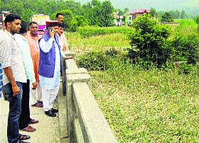 Mandi MP Ramswaroop Sharma visits the flood-affected area at Balh in Mandi on Wednesday.