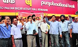 Bankers protest in support of their demands at Astley Hall in Dehradun on Wednesday