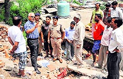DIG Garhwal Amit Sinha inspects a disaster-affected area of Kathbangla in Dehradun on Wednesday
