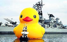 An inflatable rubber duck floats past the Battleship Iowa as part of Tall Ships Festival, in California on Wednesday