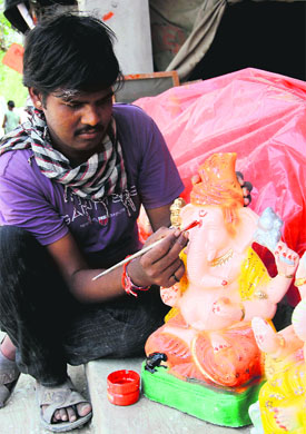 An artist colours the idol of Lord Ganesha in Bathinda on Thursday.
