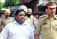 The accused in police custody. A Tribune photograph