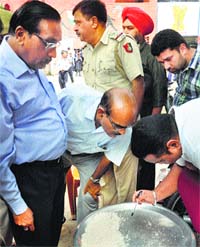 Health and Education Department officials inspect the food at Government School, Sector 45, Chandigarh on Thursday. A Tribune Photograph