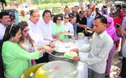 MP Kirron Kher (extreme left) distributes free food among attendants of patients outside the GMSH, Sector 16, Chandigarh, on Thursday. Tribune Photo: Pradeep Tewari