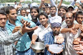 E-rickshaw drivers begging as a way of protest against the ban on plying their vehicles in east Delhi on Thursday.
