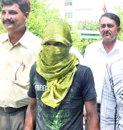 The Delhi Police Crime Branch team arrests Mazhar, alias Shekher, involved in the double murder case of Karawal Nagar in New Delhi on Thursday.