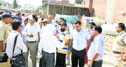 Traders argue with members of the Municipal Corporation demolition team at the Purshotam Garden link road market in Karnal on Thursday. Tribune photo: Ravi Kumar