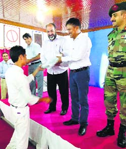 Students of J&K Sainik School, Manasbal, with Major General VPS Bhakuni (VSM), Officiating Chief of Staff, XV Corps, in Srinagar on Thursday.