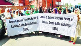 The Jammu and Kashmir Teachers Forum of Kasturba Ghandhi Balika Vidhalaya hold a protest in support of their demands in Srinagar on Thursday.