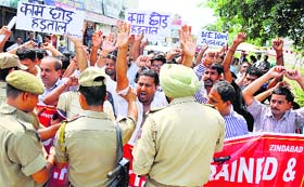 Daily wagers under the banner of the J&K PHE ITI-Trained and CP Workers Union protest during their strike in Jammu on Thursday.