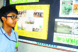 A student admires photographs at an exhibition at DCM Presidency School in Ludhiana