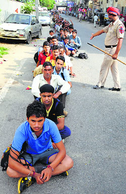 Candidates wait for their turn at an Army recruitment rally near the Jagraon Bridge in Ludhiana on Thursday.