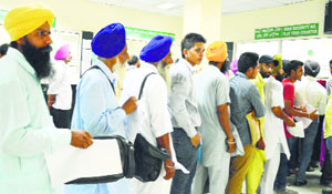 Applicants queue up at the District Transport Office in Ludhiana.