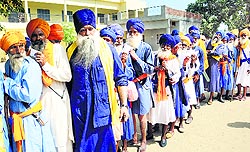 Nihangs queue up outside a polling booth to exercise their franchise in Talwandi Sabo on Thursday