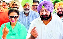 Capt Amarinder Singh and Congress candidate from Patiala Preneet Kaur show their inked finger