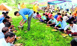 Volunteers of Shantikunj provide food to pilgrims proceeding on the Nanda Devi Raj Jaat Yatra at Karnprayag on Thursday