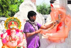 An artist paints an idol of Lord Ganesha in Bathinda on Friday. Photo: Vijay Kumar 