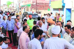 Residents of Hazi Rattan along with relatives of the deceased protest in Bathinda on Friday. Tribune photo