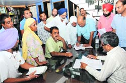 CPS Sarup Chand Singla listens to complaints at Lok Sewa Kednra in Bathinda on Friday. Tribune photo: Pawan Sharma