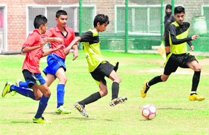 Players in action during a match of the ICSE Inter-School Football Tournament at Sector 45 in Chandigarh on Friday.