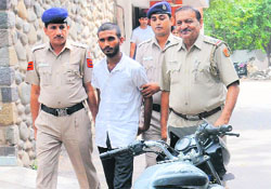 The accused being taken to court by the police in Chandigarh on Friday.