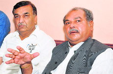 Union Minister Narendra Singh Tomar (right) talks to the media at Gharunda in Karnal district on Friday