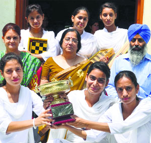 Students of Government College for Women, Parade, pose with the trophy they won in the Inter-College Chess Championship.