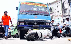 A two-wheeler hit by a city bus at the Clock Tower in Dehradun on Friday.