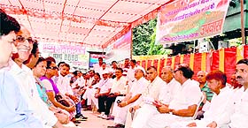Congress activists sit on a silent protest at the Chandracharya Chowk in Haridwar on Friday against booing of non-NDA chief ministers during Prime Minister Narendra Modis rallies.