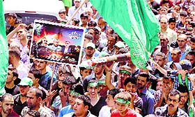 Supporters of the Palestinian Islamist Hamas movement gather during a demonstration in the West Bank city of Nablus to support people in the Gaza Strip on Friday.