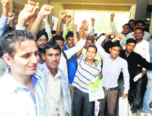 Candidates protest the postponement of interviews being conducted for the posts of sweepers, peons and others at the ESI Hospital in Jagadhri on Saturday.