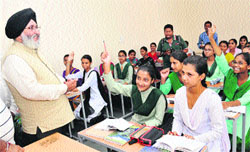Dr DS Cheema, Punjab Education Minister, interacts with students of Meritorious School in Jalandhar on Saturday. Tribune Photo Malkiat SIngh