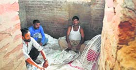 A group of men sitting in a bunker in a forward village of RS Pura on Saturday.