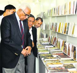 Governor NN Vohra visits a stall at the book fair in Srinagar on Saturday.