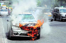 The car that caught fire at Bharat Nagar Chowk in Ludhiana.