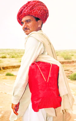 A young storytelling Bhat ready to travel with the Kaavad slung from his shoulder