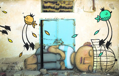 A mural by French artist SETH decorates a wall in Erriadh village, Tunisia, as part of the artistic project “Djerbahood”.