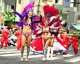 Samba dancers in colourful costumes perform through a street during the annual Asakusa Samba Carnival in Tokyo on Saturday.
