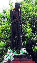 Residents tie ropes and strings to the statue of Mahatma Gandhi at Company Bagh in Amritsar