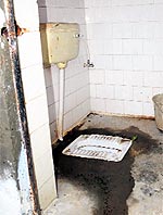 A toilet in a filthy condition